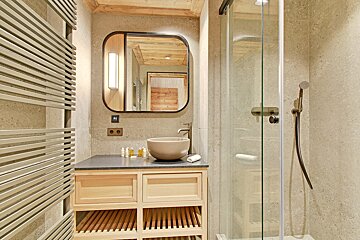 A bathroom with a sink and a walk in shower