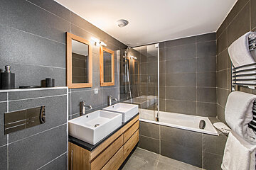 A bathroom with two sinks and a bathtub