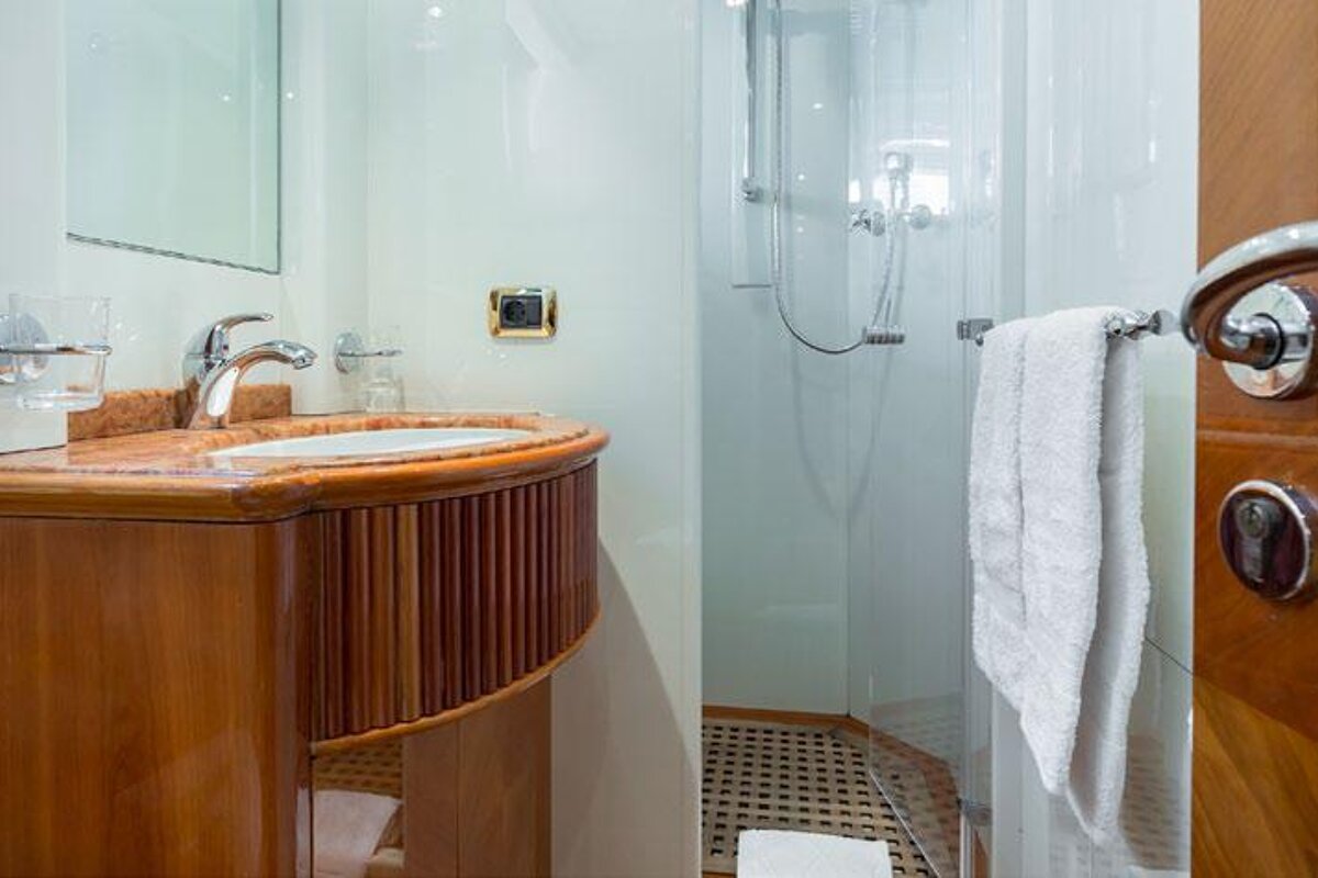 A bathroom with a sink a mirror and a shower