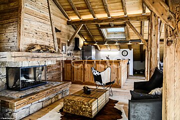 A living room with a fireplace and a cowhide rug