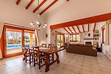 A living room with a dining table and chairs