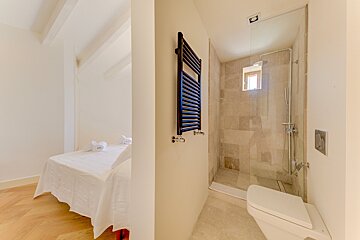 A bathroom with a toilet and a towel rack