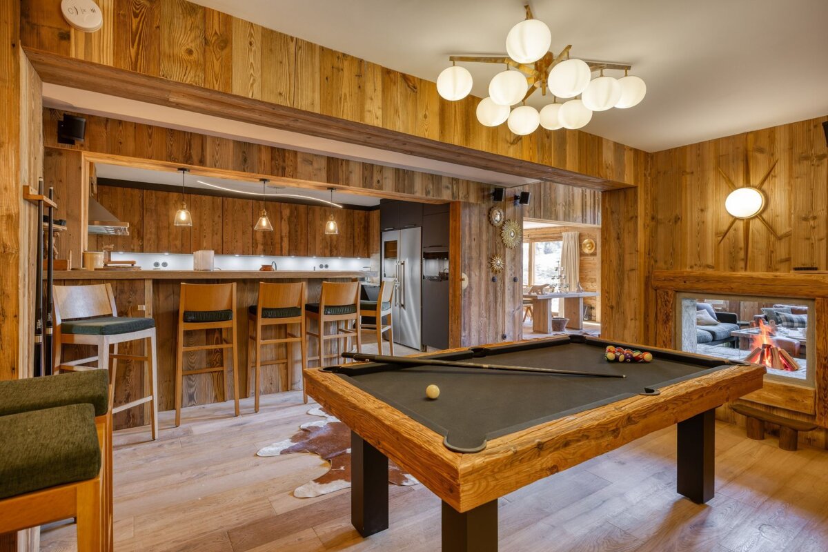 A pool table in a room with a fireplace
