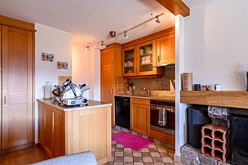 A kitchen with stainless steel appliances and wooden cabinets