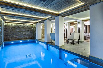 A large indoor swimming pool with blue water