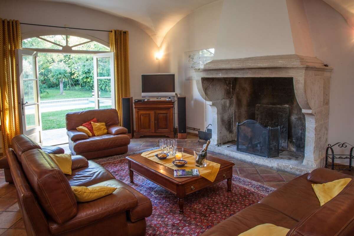 A living room with a fireplace and a flat screen tv
