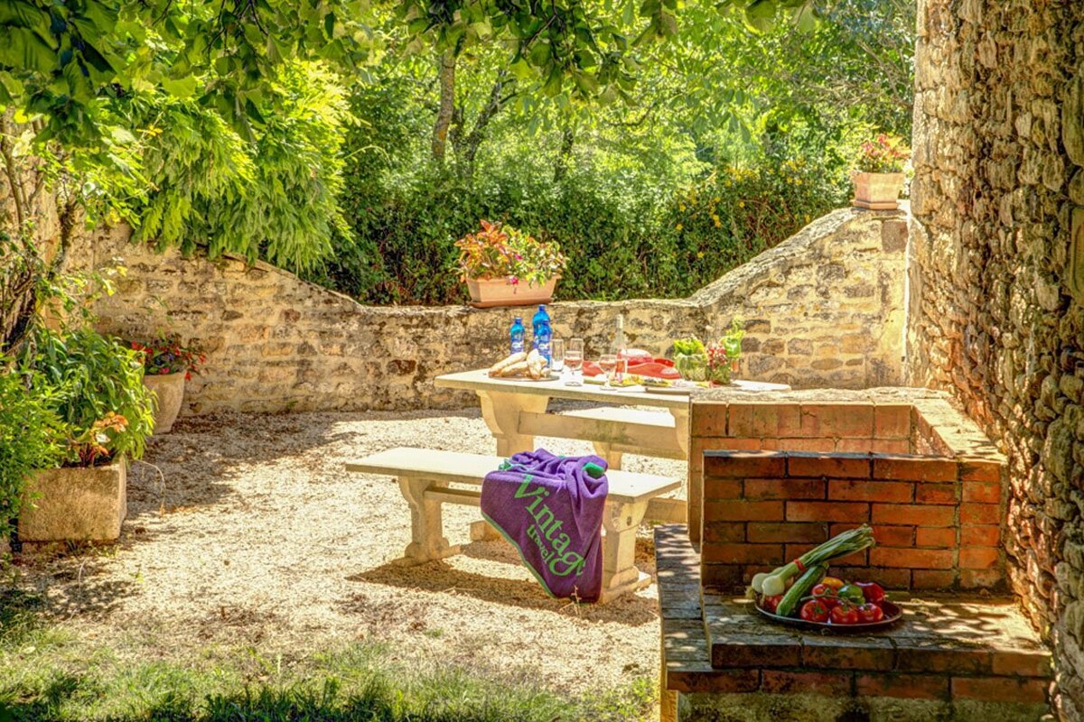 A purple virgo towel sits on a picnic table