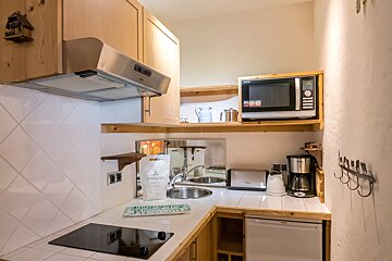 A small kitchen with a bag of graines on the counter