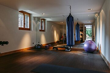 A gym with a large mirror and a purple ball