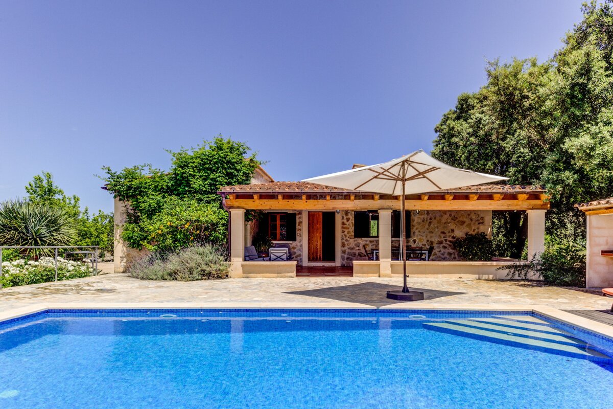 A house with a swimming pool in front of it