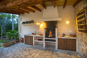 A kitchen with wooden cabinets and a fireplace