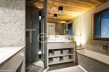 A bathroom with granite counter tops and a bathtub