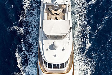 A large white yacht is floating in the ocean