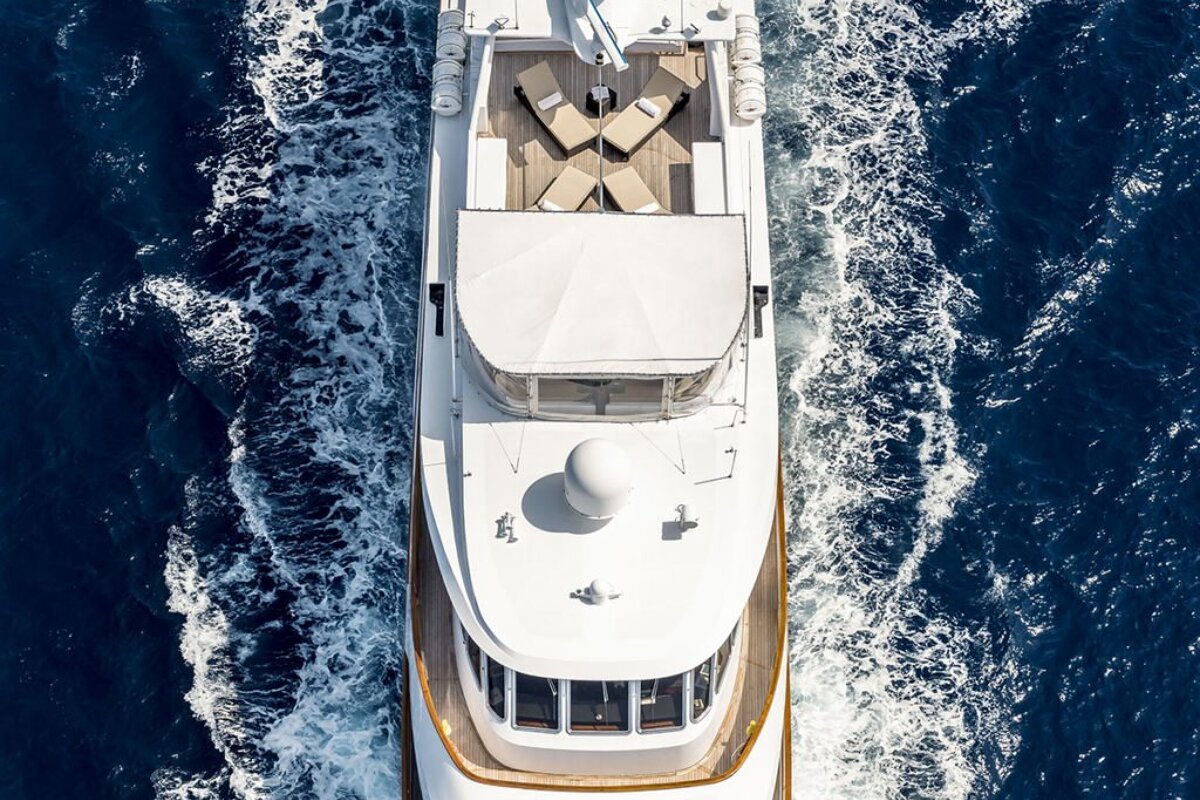 A large white yacht is floating in the ocean