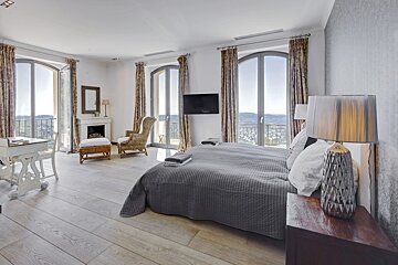 A bedroom with a large bed and a flat screen tv