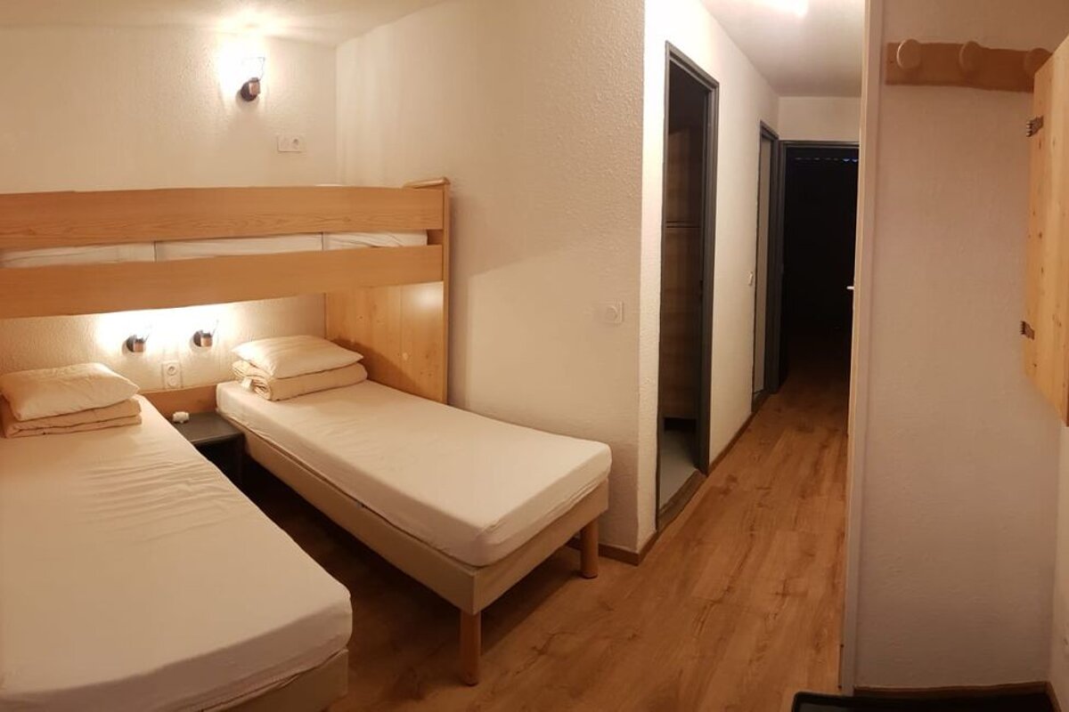 A bedroom with two beds and a door that has the number 10 on it