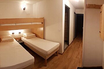 A bedroom with two beds and a door that has the number 10 on it