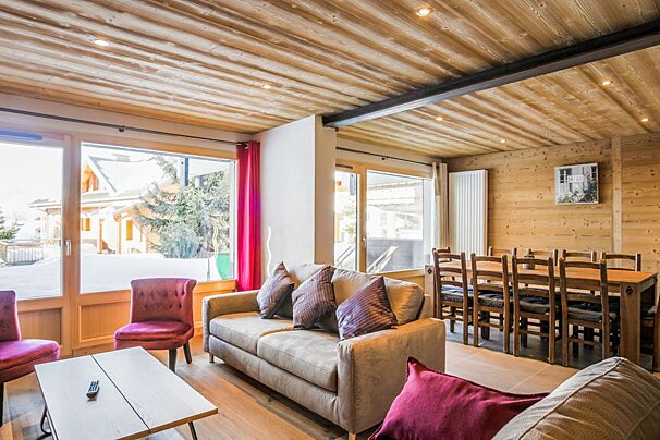 A living room with a couch and chairs and a table