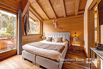 A bedroom with a bed and a knight frank logo