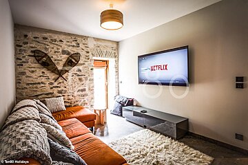 A living room with a flat screen tv that says netflix on it