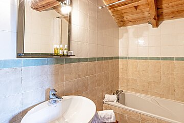 A bathroom with a sink a bathtub and a mirror