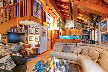 A living room with a couch a chair and a television