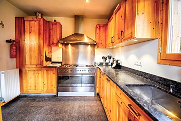 A kitchen with stainless steel appliances and wooden cabinets