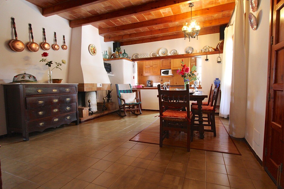 A dining room with a table and chairs and a fireplace