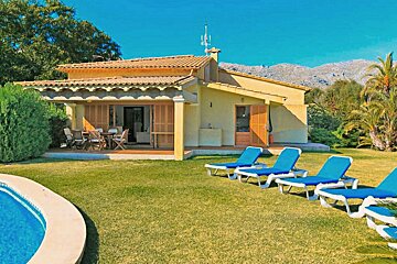 A house with a swimming pool in front of it