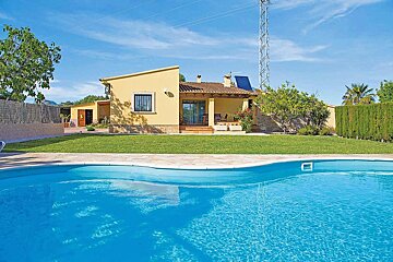 A house with a swimming pool in front of it