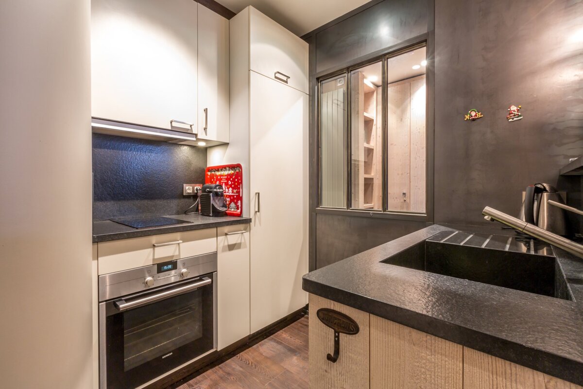 A small kitchen with the number 302 on the wall