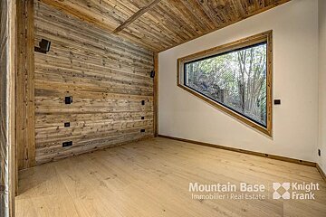 A room with a large window and the words mountain base knight frank on the bottom