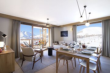 A living room with a dining table and chairs