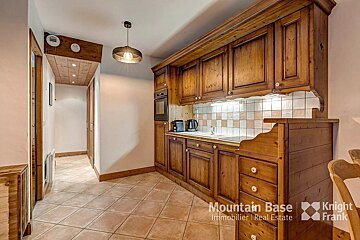 A kitchen with wooden cabinets and a sign that says mountain base
