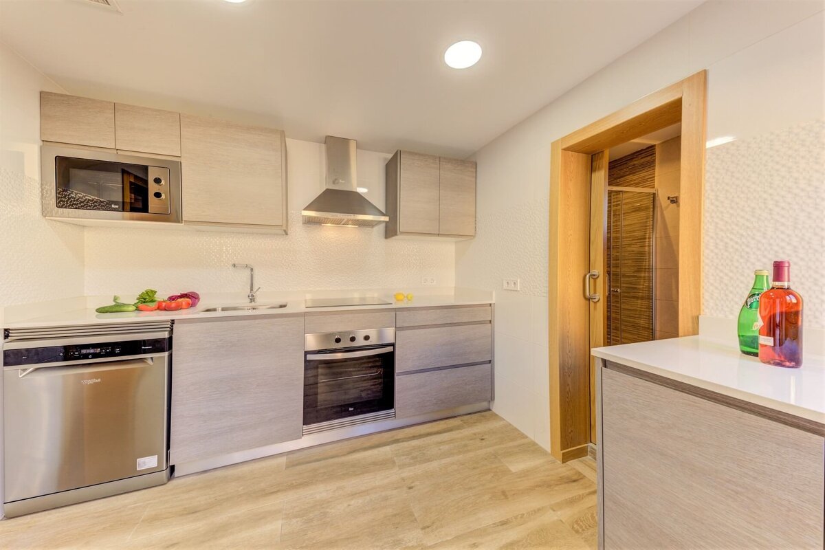 A kitchen with a bottle of rose wine on the counter