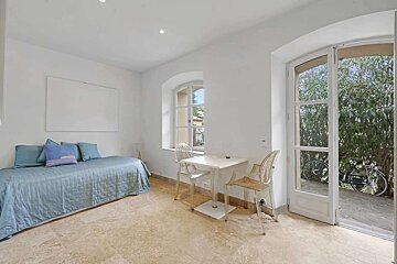 A bedroom with a bed a desk and a chair