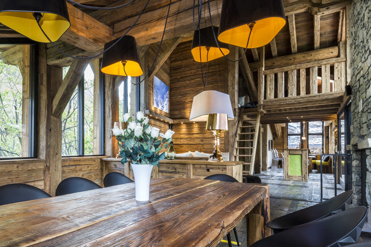A wooden table with a vase of flowers on it