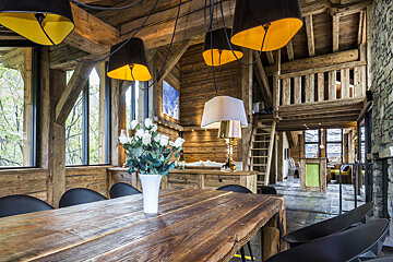 A wooden table with a vase of flowers on it