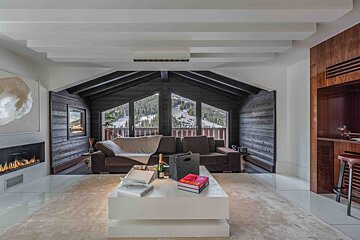 A living room with a couch and a fireplace