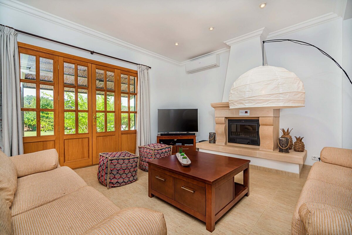 A living room with a fireplace and a flat screen tv