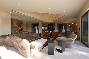 A living room with a couch and two chairs