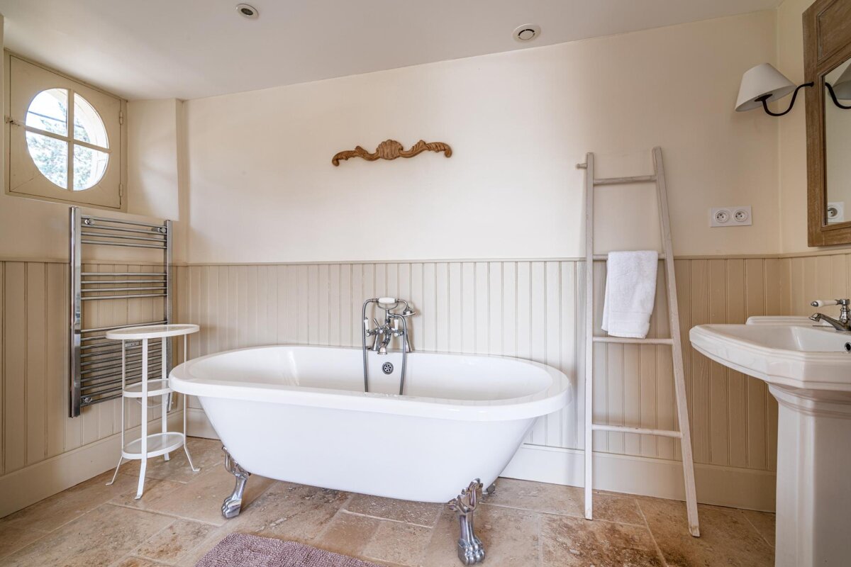 A bathroom with a claw foot tub and a sink