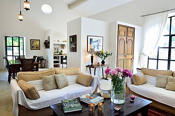 A living room with two couches and a book on the coffee table