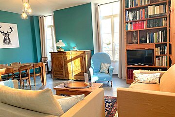 A living room with a dining table and chairs