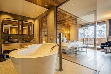 A bathroom with a bathtub and two sinks