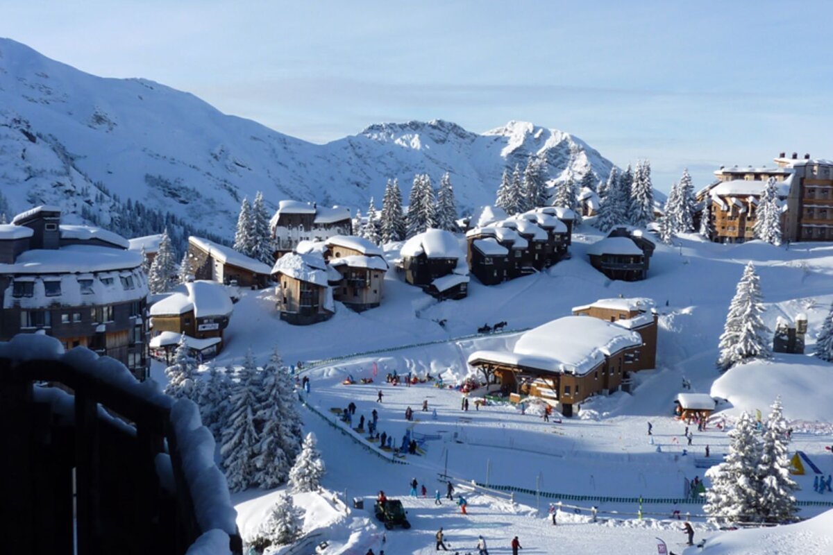 A ski resort with a lot of snow on the buildings