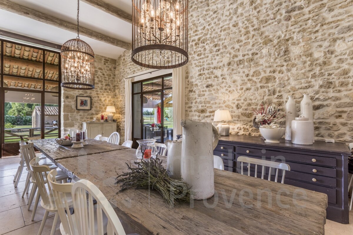 A dining room with a stone wall and the word provence on the table