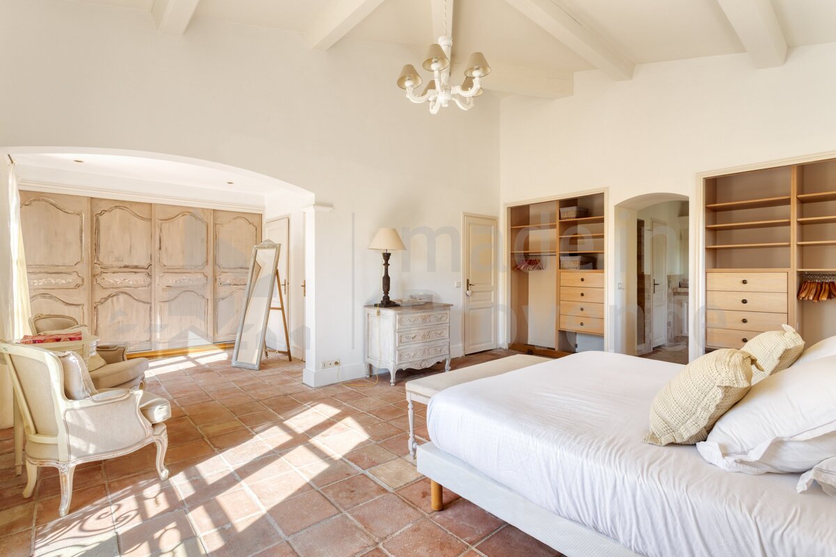 A bedroom with a large bed and lots of closets