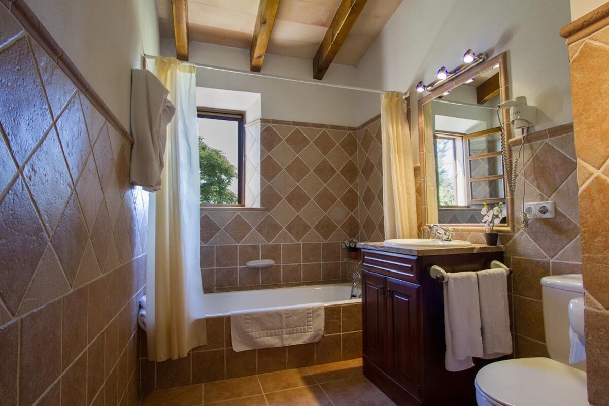 A bathroom with a sink and toilet and a bathtub
