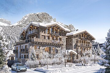 Luxurious stone and wood alpine chalets stand majestically in a pristine snowy mountain setting with frosted trees, a car, and people.